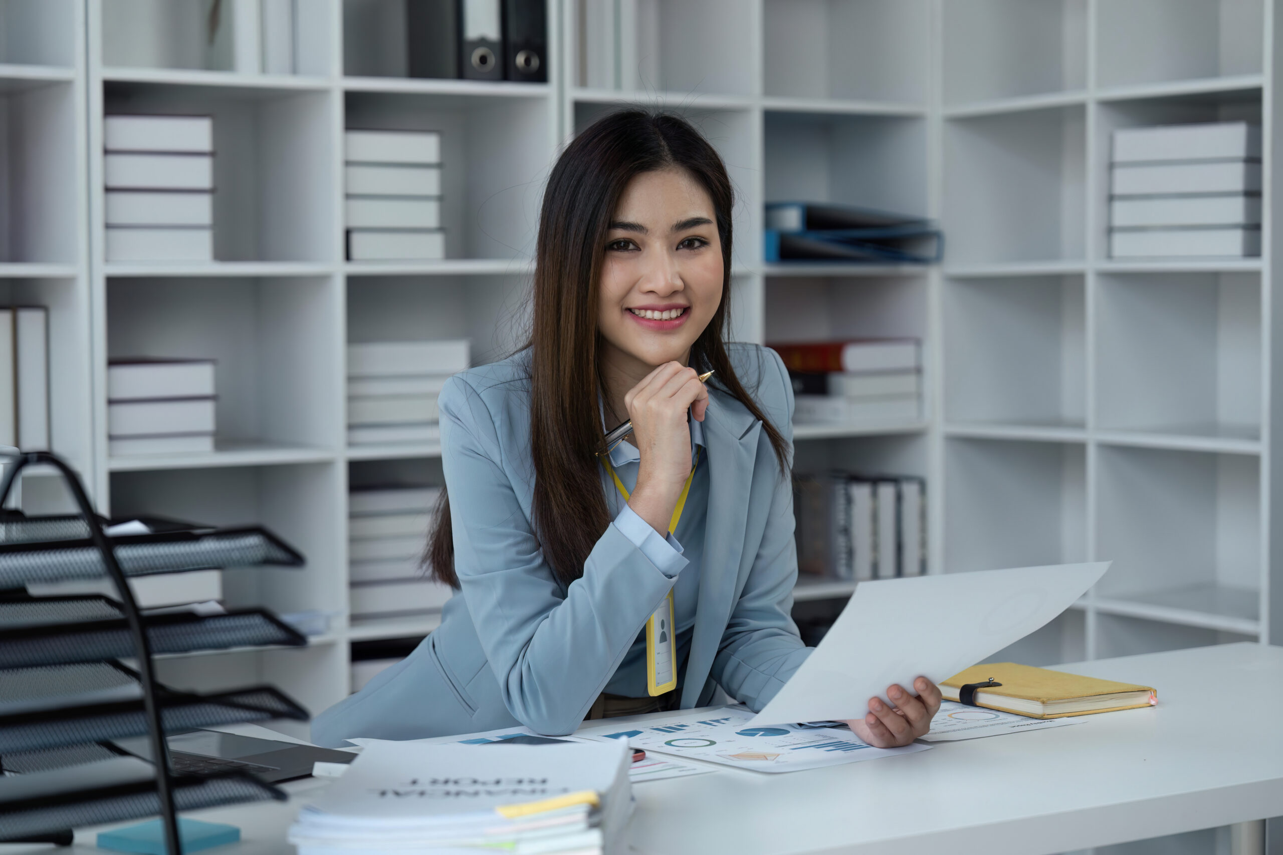 A direct sales professional sitting happily in her own office space.